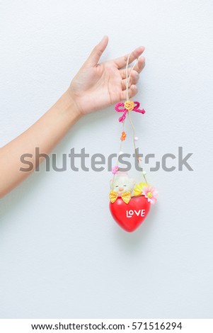 Valentines day background with dangling inscription Love and Hearts on white background. Doodle inscription and Hearts. Vector Handmade art. Can be use as t-shirt, poster, banner, cards and etc.