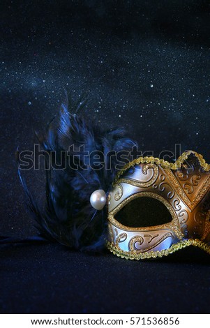 Image of black elegant venetian mask on glitter background


