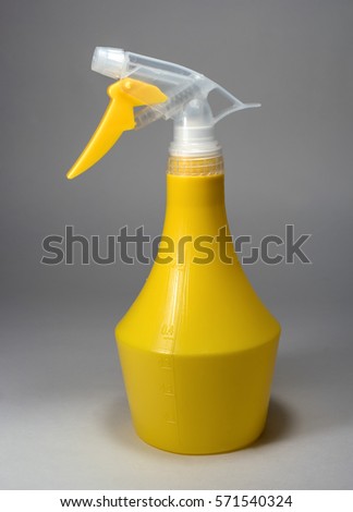 Spray bottle with blank label on a light background.