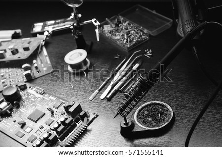 soldering iron repair work. black and white photo