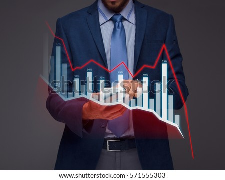 Businessman with chart in the fall, economy going down. Royalty-Free Stock Photo #571555303