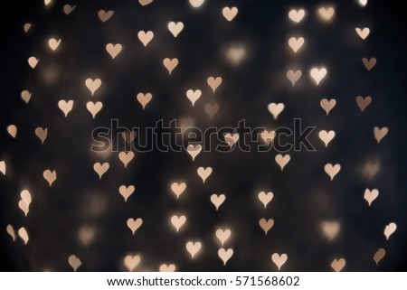 Heart bokeh on dark background. Valentine's Day Background.