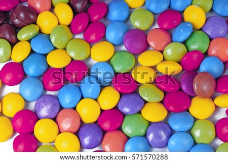 Closeup of pile colorful chocolate candies. Colorful candies in rainbow colors. Candy texture. Candy pattern. Sweets as background with a lot of colors. 