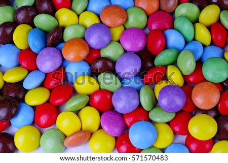 Closeup of pile colorful chocolate candies. Colorful candies in rainbow colors. Candy texture. Candy pattern. Sweets as background with a lot of colors. 