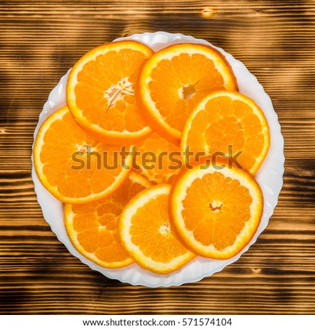 dish of sliced oranges on burnt wooden desk with. food pattern