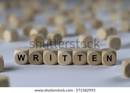 written - cube with letters, sign with wooden cubes