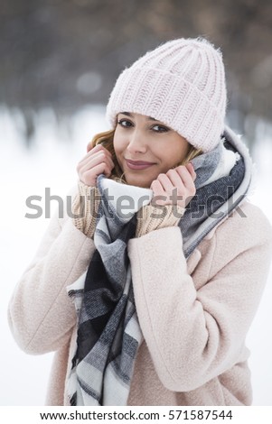 Portrait of a beautiful blonde woman in in the snow
