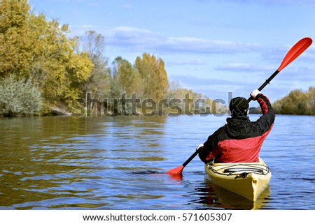 Journey down the river on a sunny day in a canoe. Royalty-Free Stock Photo #571605307