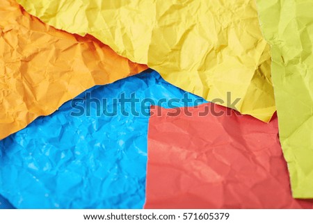 Surface coated with the multiple colorful crumpled origami paper sheets as an abstract background composition
