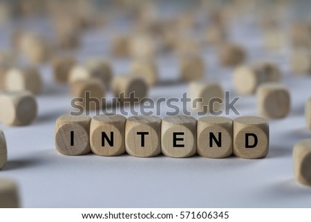intend - cube with letters, sign with wooden cubes