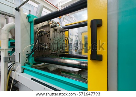 Injection moulding machine used for the forming of plastic parts using plastic resin and polymers Royalty-Free Stock Photo #571647793