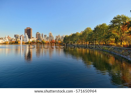 Skyscrapers at east side of Central Park over lake in Autumn in New York City.