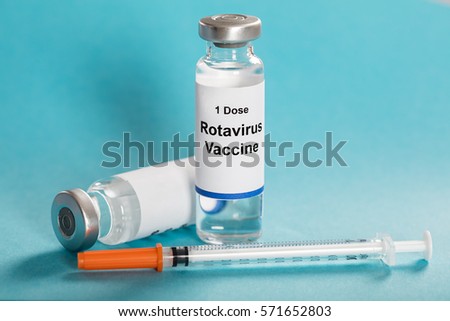 Rotavirus Vaccine Vials With Syringe Over Turquoise Background Royalty-Free Stock Photo #571652803