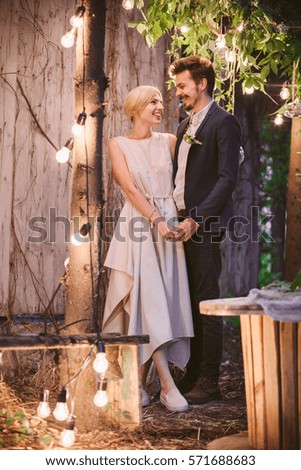 Beautiful wedding casual couple in love between trees with decoration 