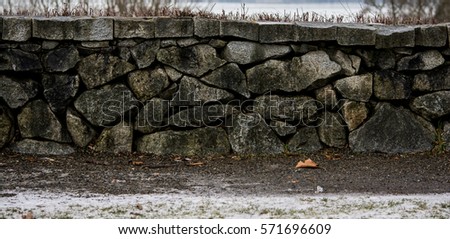 Winter Stone Wall: This stone wall is located in Discovery Park - Seattle, Washington. Royalty-Free Stock Photo #571696609