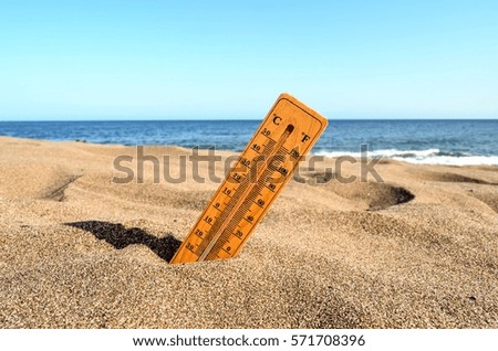 Photo Picture of a Thermometer on the Sand Beach