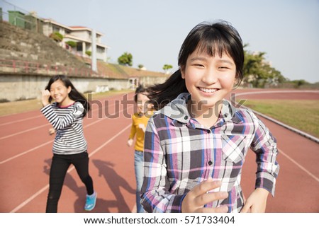 happy teenager girls running on the track