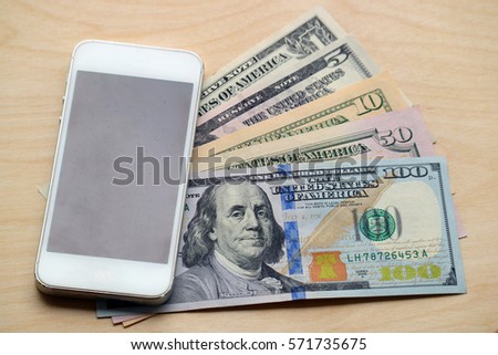 Mobile Smart phone and dollar cash on wood background, digital money and fintech concept