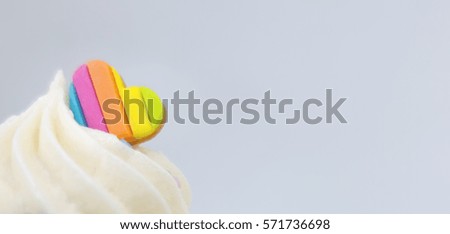 Valentines rainbow heart on top of cupcake with copy space