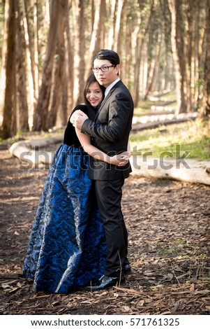 Couple posing in the forest for engagment photo