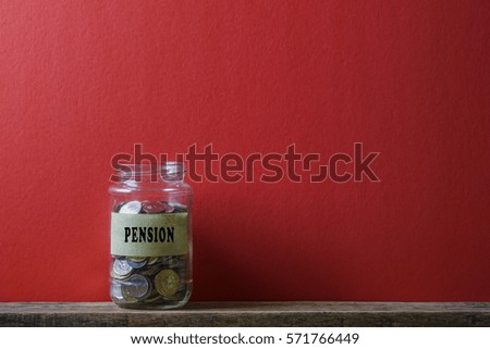 Jar of coins on red background with business conceptual text.