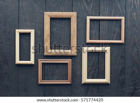vintage frames on old wooden wall
