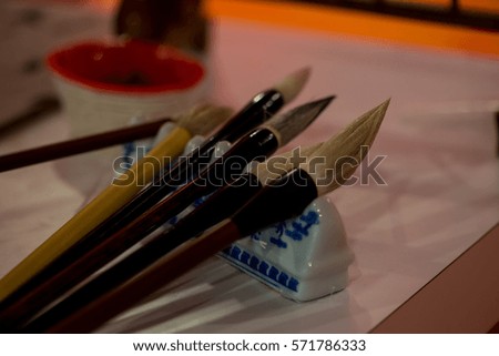 Various kind of Asian brushes arranged on a table