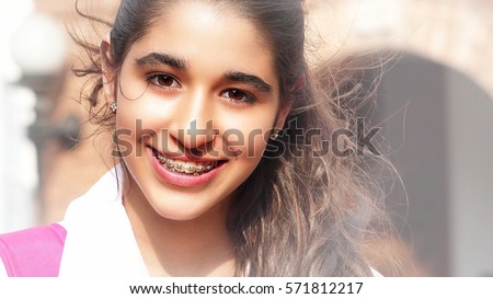 Pretty Smiling Teen Girl with Braces Royalty-Free Stock Photo #571812217