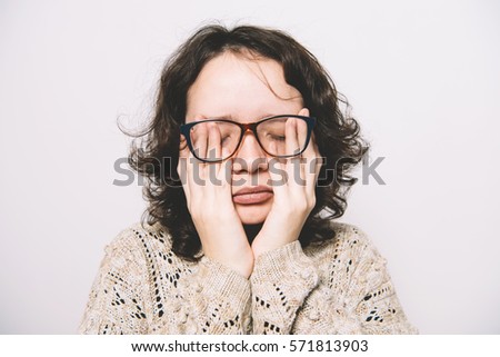 fatigue of a young girl in a photo studio. Pain, depression, fatigue.