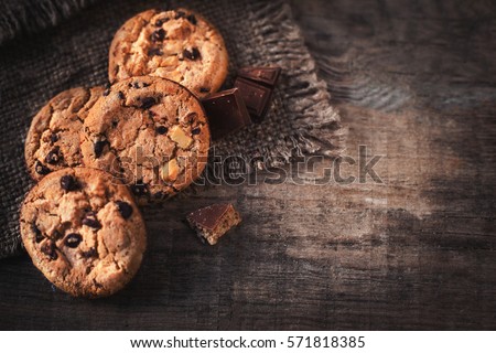 Chocolate chip cookies on dark old wooden table with place for text.,  freshly baked. Selective Focus with Copy space. Royalty-Free Stock Photo #571818385