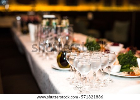 Wineglasses with water stand on rich served dinner table