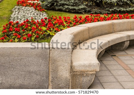 A stone bench in the shape of a circle. Landscape design, greening urban areas. Major European city. On the geographical border of Europe and Asia. Landscaped walking area. Vacation in Yekaterinburg.