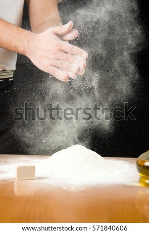Man shaking of flour from his hands