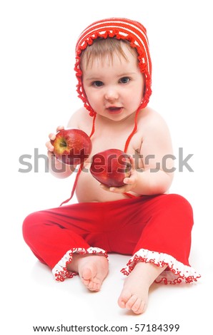 little girl with red apples.she is sitting in the floor