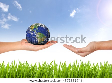 Earth planet the hand on nature and blue sky background - Corporate social responsibility concept. - Elements of this image furnished by NASA
