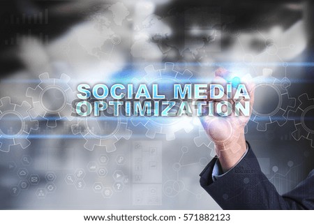 Businessman drawing on virtual screen. social media optimization concept.