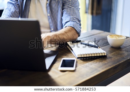 Cropped image of IT developer coding new program working hard early in morning brainstorming while finding creative solution using wireless connection to internet in coworking space and laptop