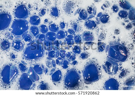 soap bubbles cleaning agent on the surface of the water