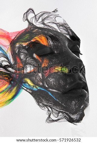 Attractive man's portrait fading and flowing into lines and colorful brushstrokes 

