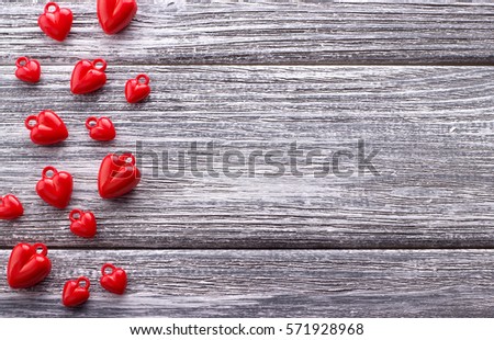 Multiple red hearts on gray painted rustic white wooden background. Valentine Day.