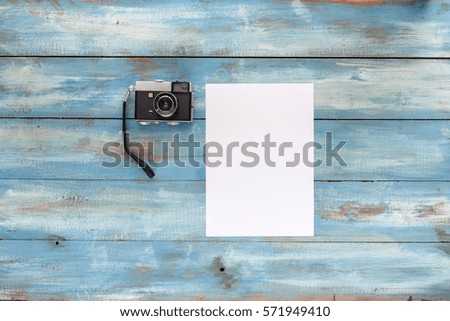 Photo camera on a blue old vintage wooden blue background. Photographed in retro style