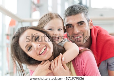 Young happy family in shopping mall Royalty-Free Stock Photo #571979536