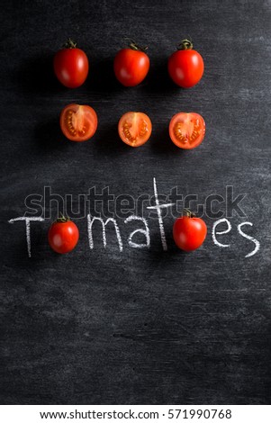 Top view picture of a lot of tomatoes over dark background