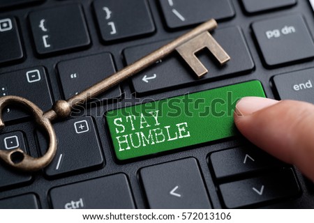 Closed up finger on keyboard with word STAY HUMBLE Royalty-Free Stock Photo #572013106