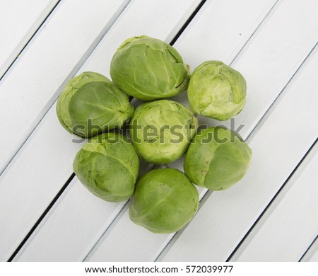 Brussel sprout vegetables over wooden background