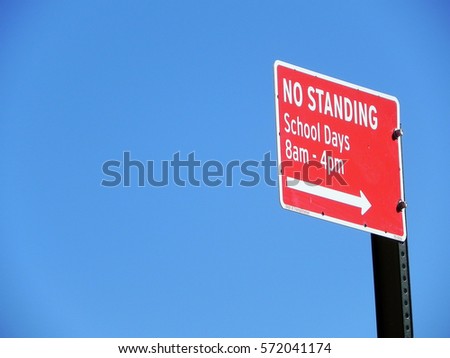 no standing sign in front of blue sky