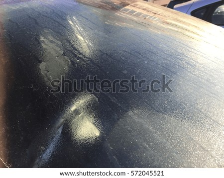Car window with water drops on glass background