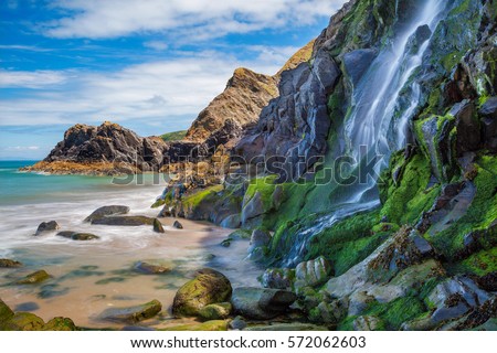 Waterfall, Tresaith Beach, Ceredigion,Cardigan,  West Wales, UK Royalty-Free Stock Photo #572062603