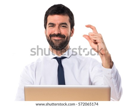 Businessman in his office doing tiny sign