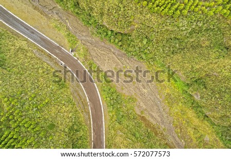 Breathtaking aerial view of a scenic unpaved road winding through the countryside,perfect for off road enthusiasts and nature lovers.